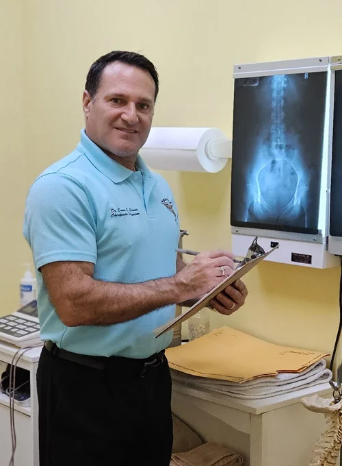 Dr. Ernest Caruso examining x-rays